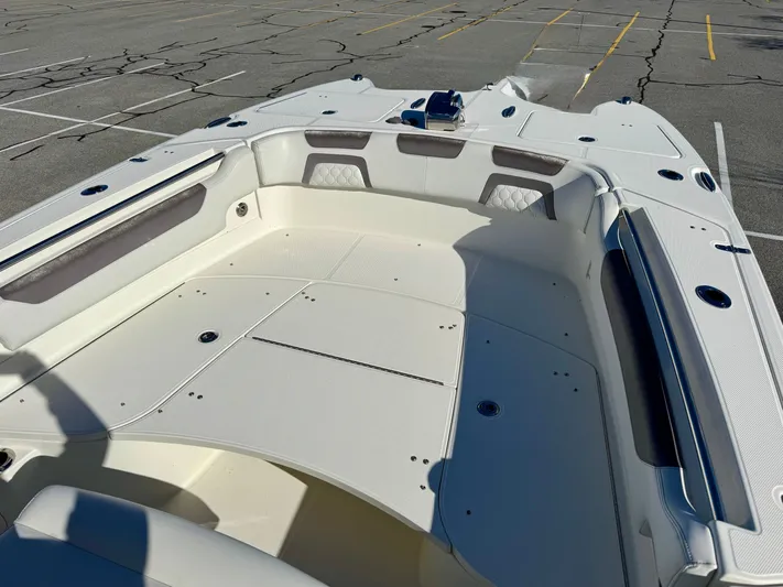 Reelaxing Yacht Photos Pics 2017 World Cat 295 CC boat interior with spacious seating in a parking lot.