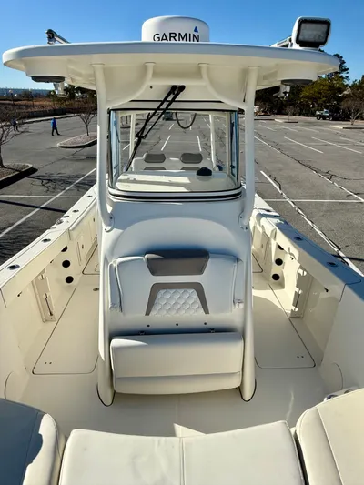 Reelaxing Yacht Photos Pics 2017 World Cat 295 CC boat with Garmin equipment, parked in an empty lot.