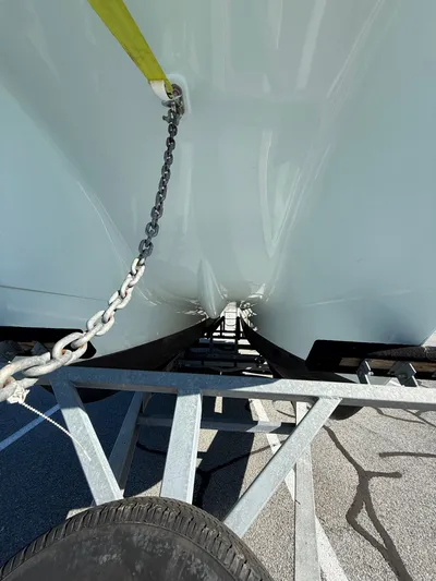 Reelaxing Yacht Photos Pics 2017 World Cat 295 CC boat hull on trailer, secured with chain.