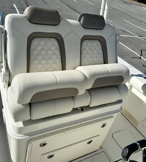 Reelaxing Yacht Photos Pics 2017 World Cat 295 CC boat seats with cushioned armrests and hexagonal pattern design.
