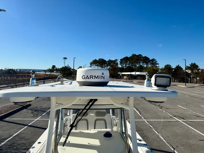 Reelaxing Yacht Photos Pics 2017 World Cat 295 CC boat with Garmin equipment, parked under clear blue sky.
