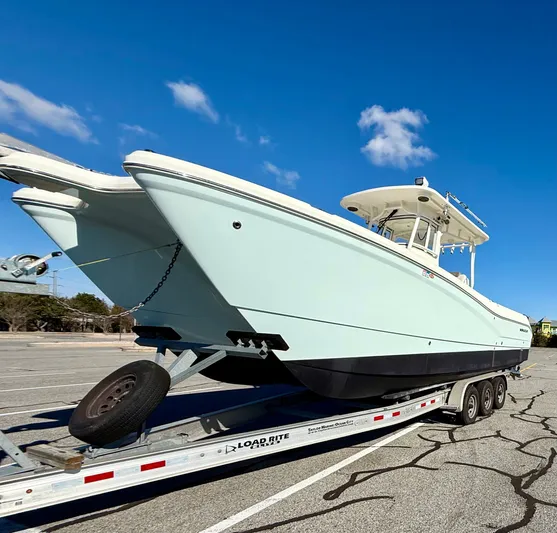 Reelaxing Yacht Photos Pics 2017 World Cat 295 CC boat on trailer under clear blue sky.