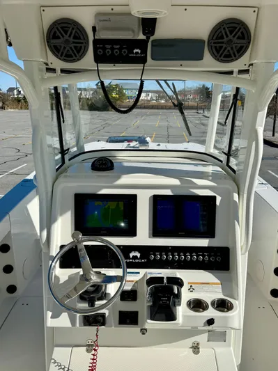 Reelaxing Yacht Photos Pics 2017 World Cat 295 CC boat dashboard with steering wheel, navigation screens, and controls.
