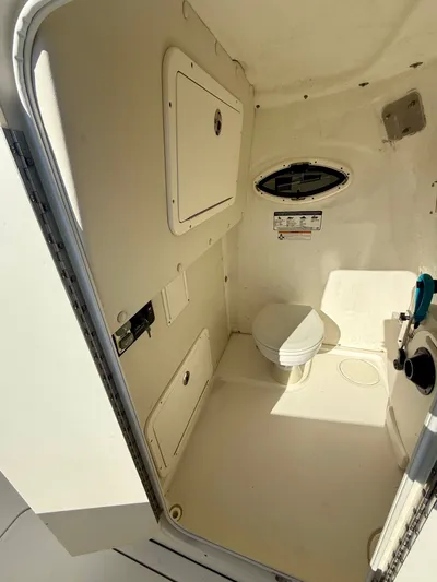 Reelaxing Yacht Photos Pics Interior of 2017 World Cat 295 CC boat featuring a compact marine toilet.