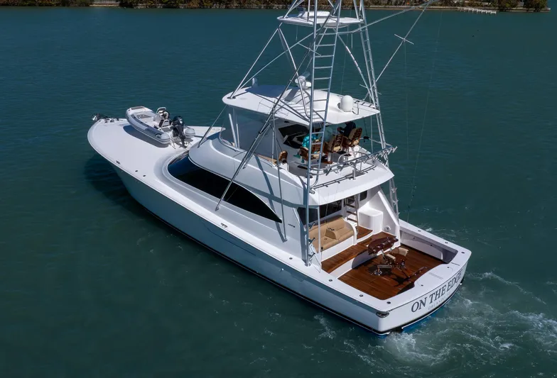 On The Edge III Yacht Photos Pics 2019 Viking 62 Convertible yacht cruising on calm blue waters.