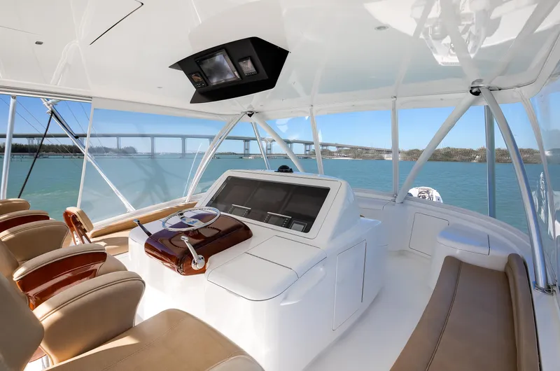 On The Edge III Yacht Photos Pics 2019 Viking 62 Convertible yacht helm with leather seats and panoramic ocean view.