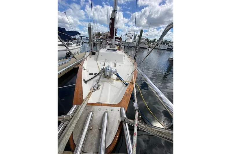 Irish Rose Yacht Photos Pics 1995 Pacific Seacraft Crealock 34 sailboat docked at marina under cloudy sky.