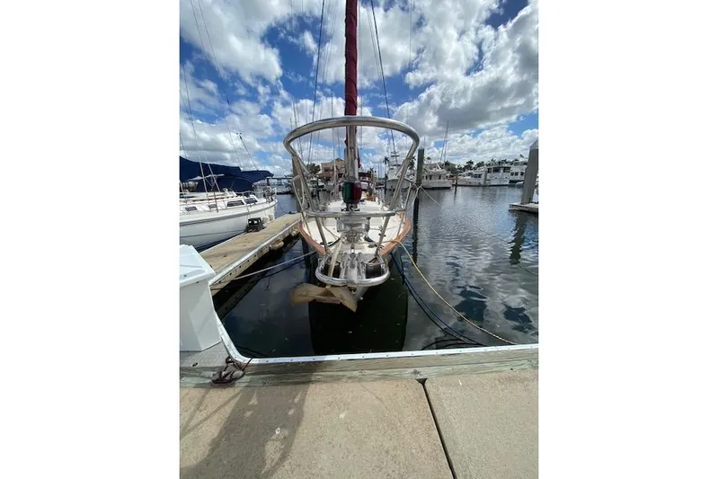 Irish Rose Yacht Photos Pics 1995 Pacific Seacraft Crealock 34 sailboat docked at marina under cloudy sky.