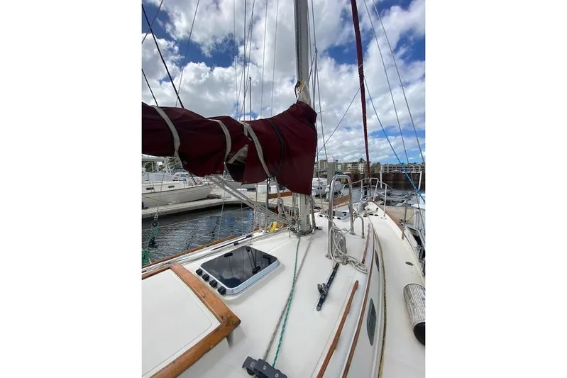 Irish Rose Yacht Photos Pics Sailboat deck view of 1995 Pacific Seacraft Crealock 34 with rigging and cloudy sky.