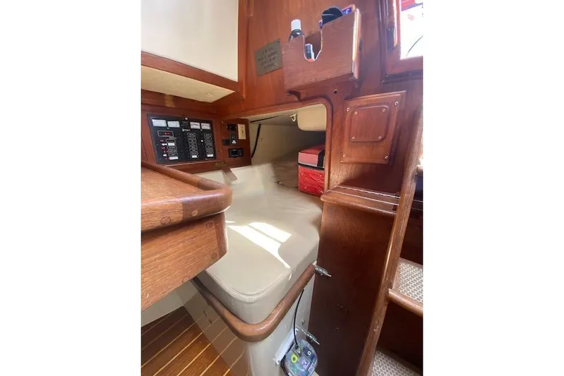 Irish Rose Yacht Photos Pics Interior of 1995 Pacific Seacraft Crealock 34 sailboat with wooden cabinetry and control panel.