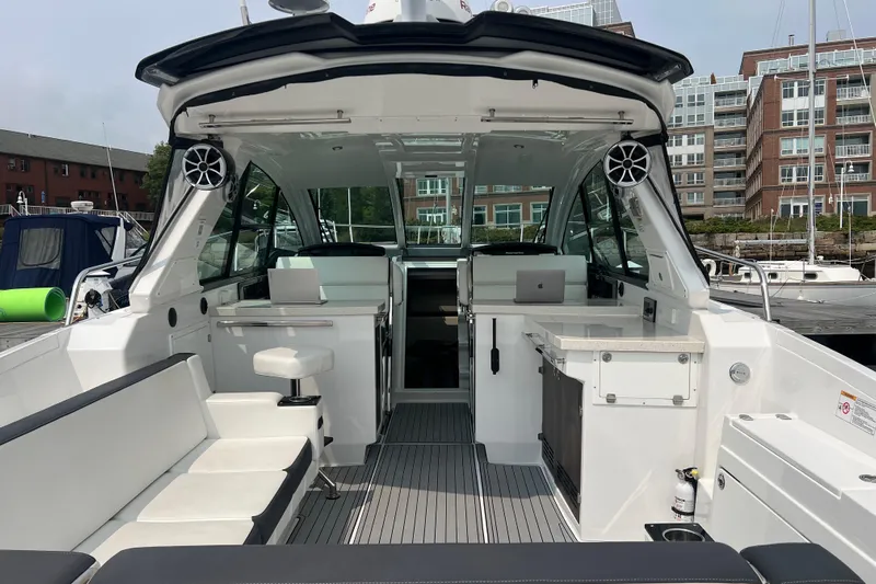 On Sebbatical Yacht Photos Pics 2018 Monterey 360 Sport Coupe interior with seating and modern amenities at a marina.