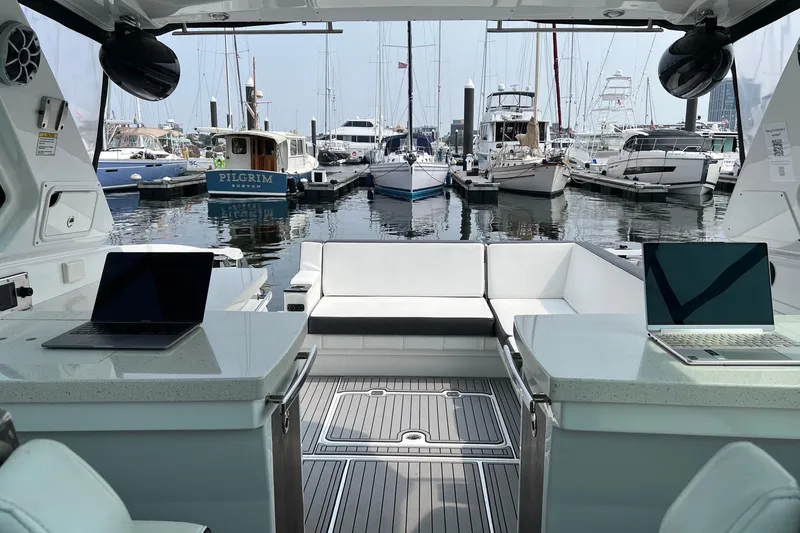 On Sebbatical Yacht Photos Pics Luxury 2018 Monterey 360 Sport Coupe yacht interior with laptops, docked at marina.