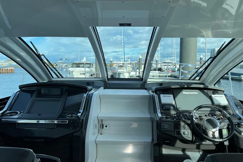 On Sebbatical Yacht Photos Pics Interior view of 2018 Monterey 360 Sport Coupe yacht cockpit with marina backdrop.