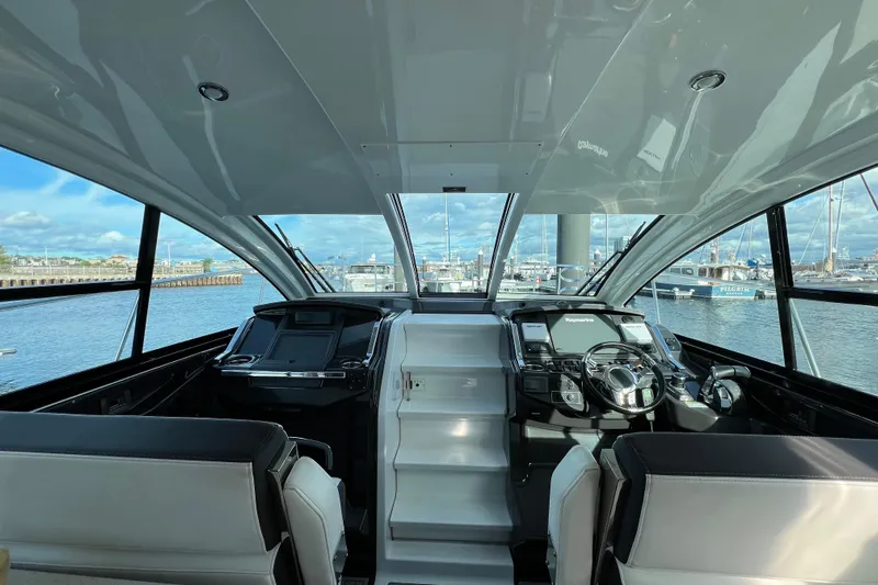 On Sebbatical Yacht Photos Pics Interior view of 2018 Monterey 360 Sport Coupe yacht with modern helm and marina backdrop.