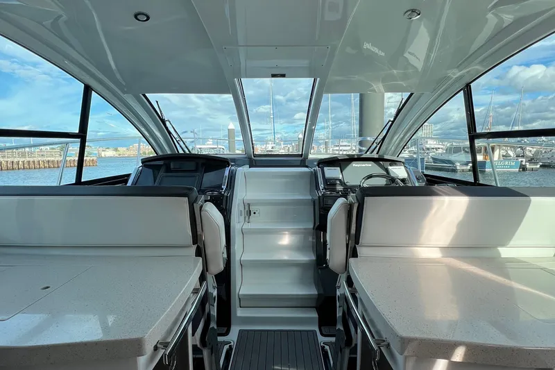 On Sebbatical Yacht Photos Pics Interior view of a 2018 Monterey 360 Sport Coupe yacht with marina backdrop.