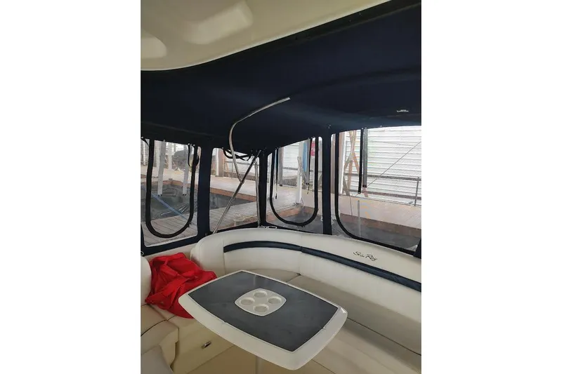  Yacht Photos Pics 2005 Sea Ray 390 Sundancer interior with seating and table, featuring enclosed windows.