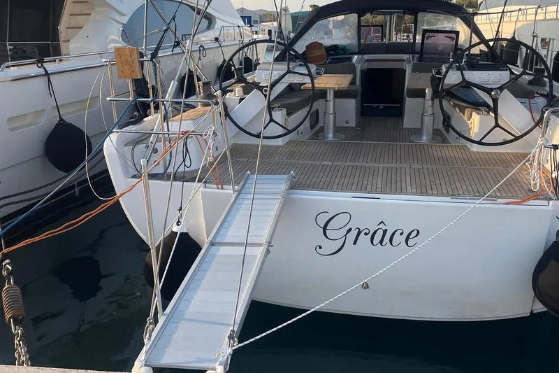  Yacht Photos Pics 2013 Hanse 575 yacht "Grâce" docked with open cockpit and dual steering wheels.