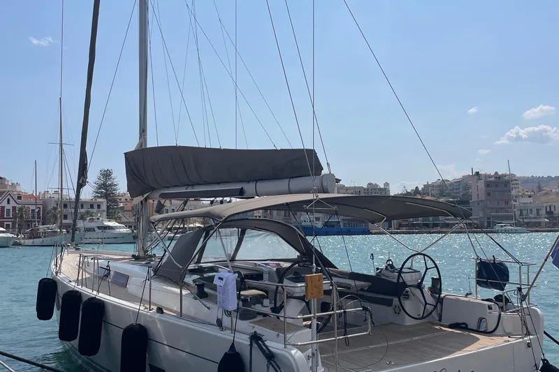  Yacht Photos Pics Sailing yacht Hanse 575, 2013 model, docked in a sunny marina with cityscape background.