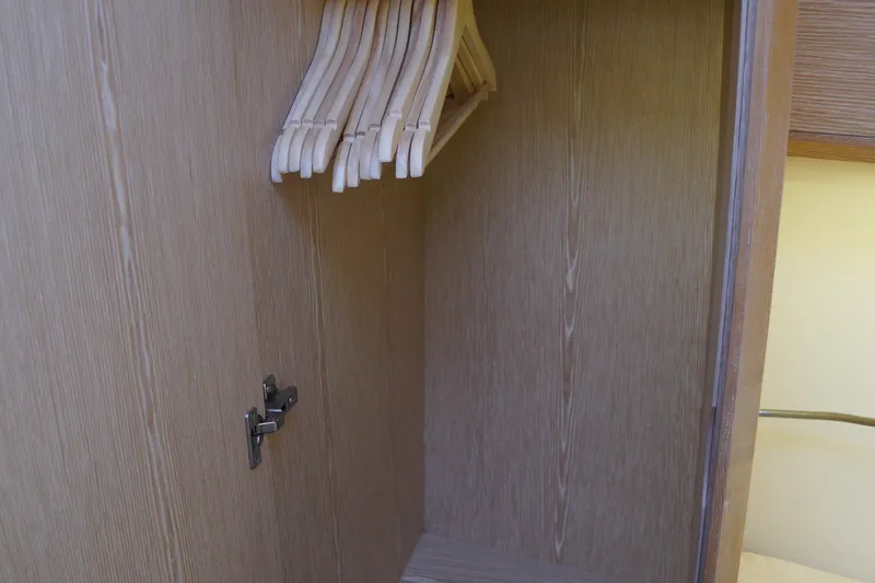  Yacht Photos Pics Wooden closet with hangers inside a 2013 Hanse 575 yacht.