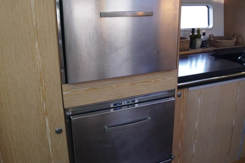  Yacht Photos Pics Modern kitchen in 2013 Hanse 575 yacht with stainless steel appliances and wooden cabinetry.