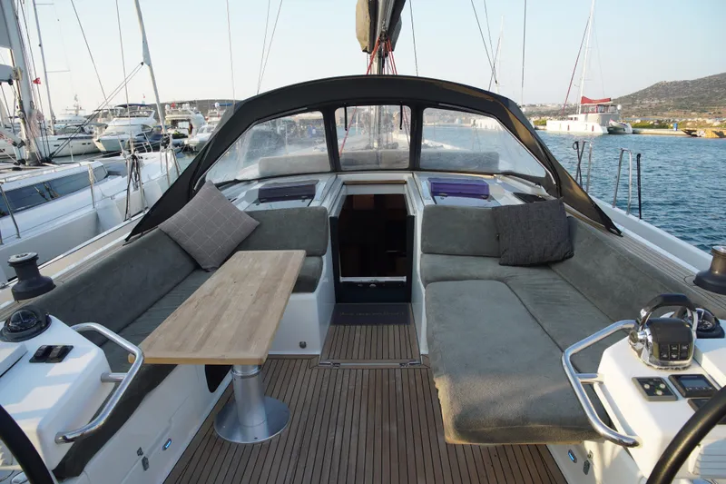  Yacht Photos Pics Luxurious 2013 Hanse 575 yacht cockpit with comfortable seating and wooden table.