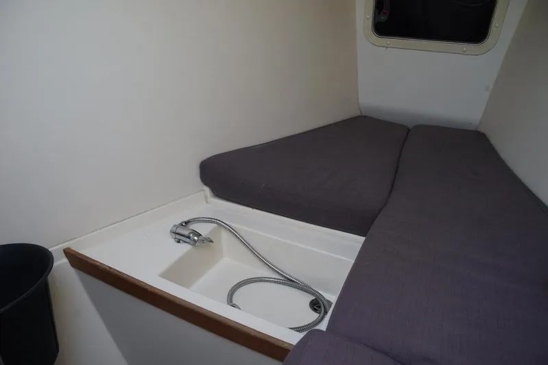  Yacht Photos Pics Interior cabin of 2013 Hanse 575 yacht with compact bed and sink.