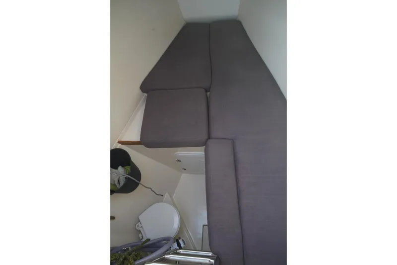  Yacht Photos Pics Interior cabin view of 2013 Hanse 575 yacht with gray cushions and compact toilet.