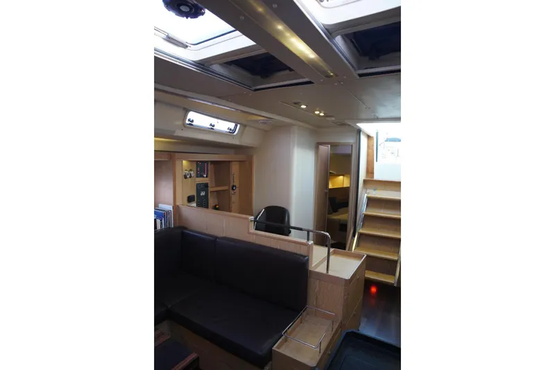  Yacht Photos Pics Interior of 2013 Hanse 575 yacht, featuring modern design with wooden finishes and seating area.