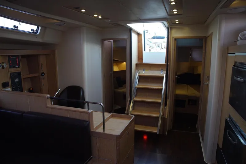  Yacht Photos Pics Interior of 2013 Hanse 575 yacht, featuring modern wood finishes and cozy cabin spaces.