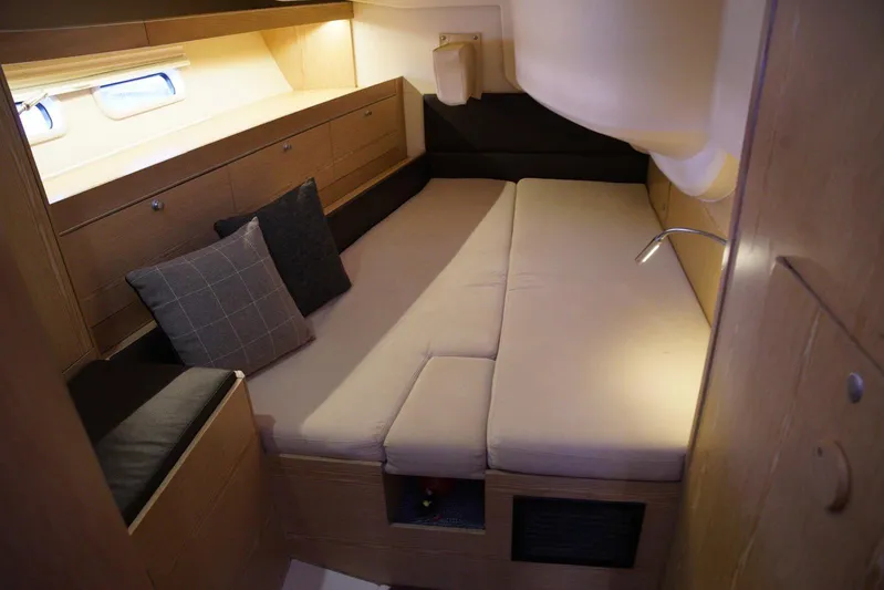  Yacht Photos Pics Interior cabin of 2013 Hanse 575 yacht with cozy bed and wooden furnishings.