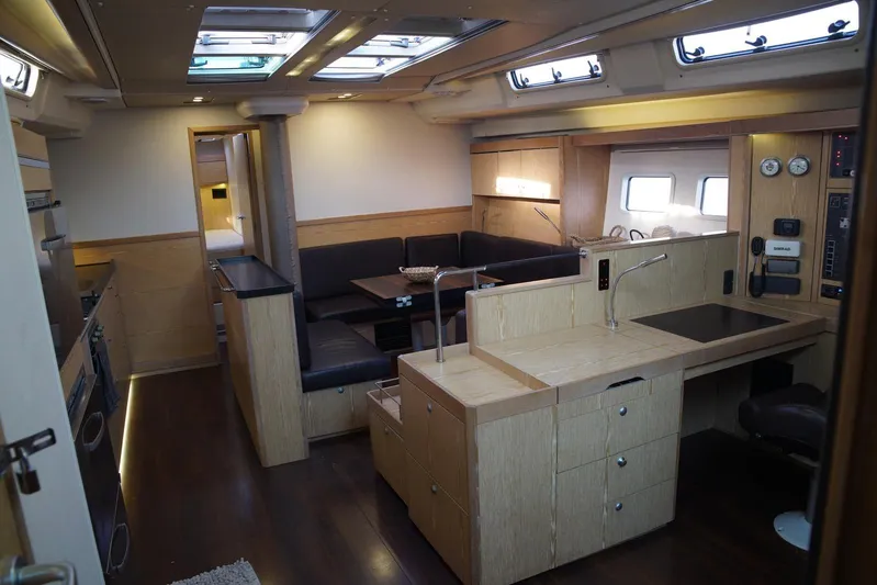  Yacht Photos Pics Interior of 2013 Hanse 575 yacht with modern kitchen and dining area.