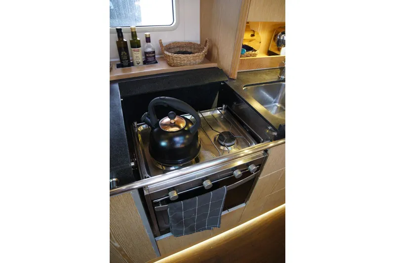  Yacht Photos Pics Compact kitchen in 2013 Hanse 575 yacht with stove, kettle, and sink.