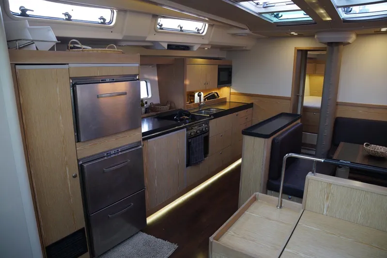  Yacht Photos Pics Luxurious interior of 2013 Hanse 575 yacht featuring modern kitchen and dining area.