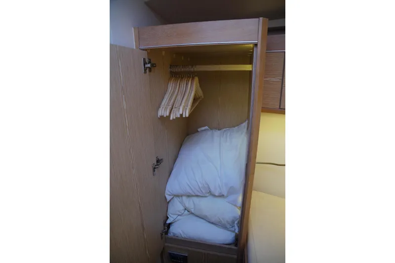  Yacht Photos Pics Wooden closet with hangers and bedding in a 2013 Hanse 575 yacht.