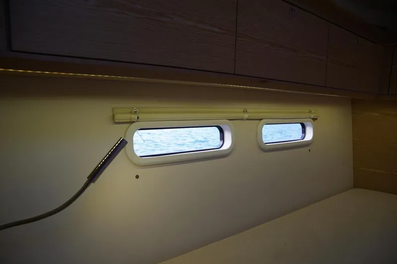  Yacht Photos Pics Interior view of 2013 Hanse 575 yacht cabin with porthole windows.