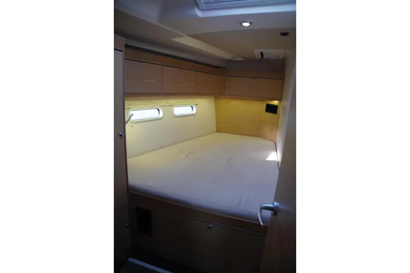  Yacht Photos Pics Cozy cabin interior of 2013 Hanse 575 yacht with wooden finish and natural light.