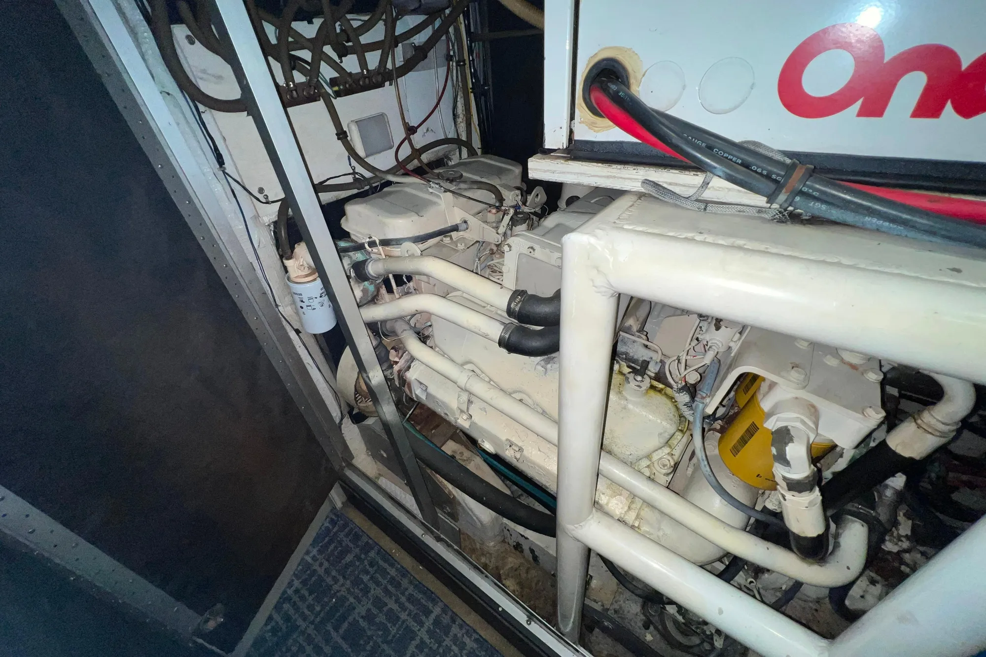 Engine compartment of 1989 Bayliner 4285 Avanti, featuring Onan generator and complex wiring.