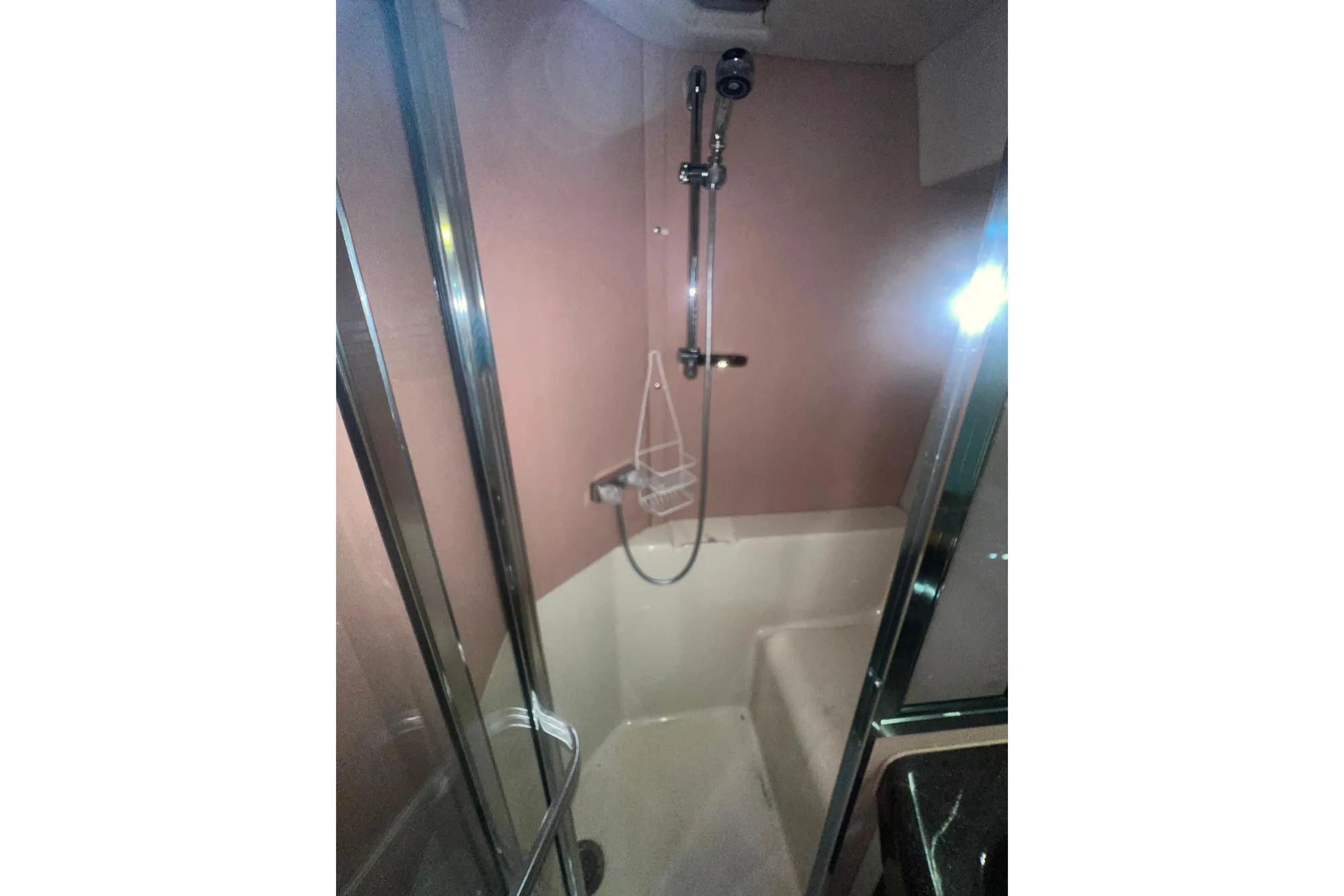 Shower area in 1989 Bayliner 4285 Avanti yacht with glass door and modern fixtures.