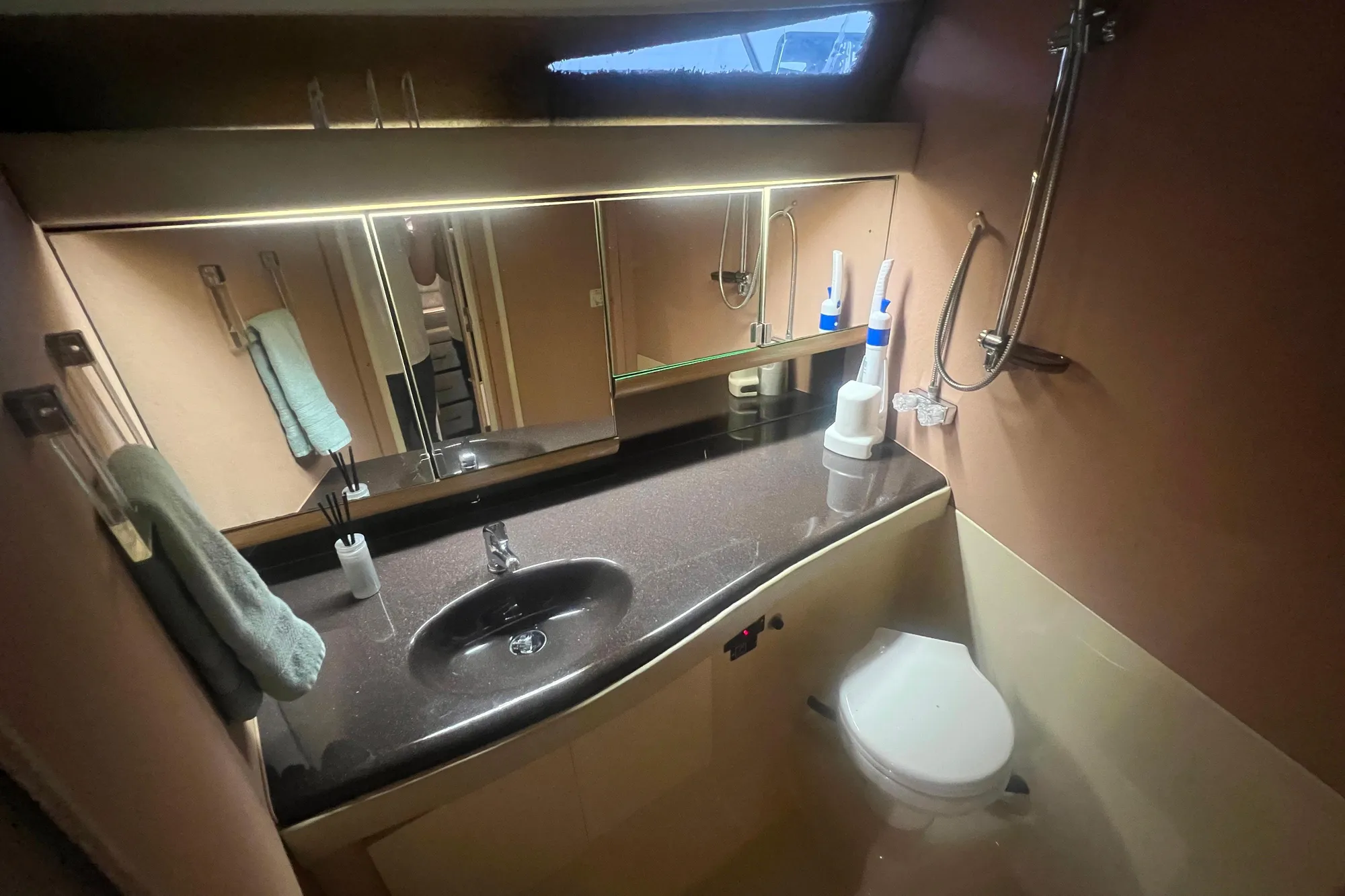 Bathroom interior of 1989 Bayliner 4285 Avanti yacht with sink and toilet.