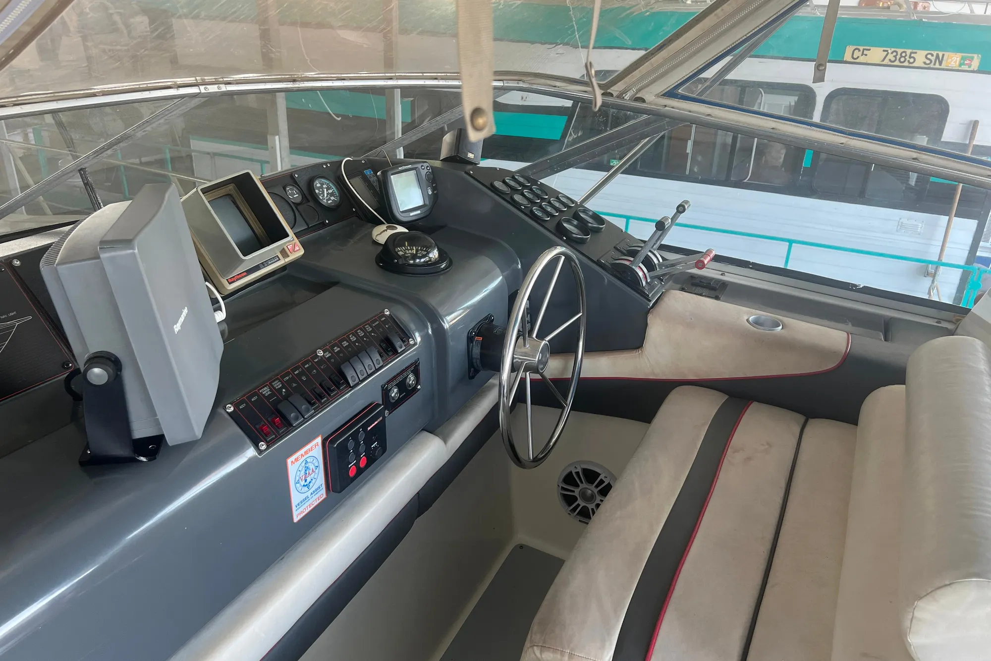 1989 Bayliner 4285 Avanti helm with steering wheel, navigation equipment, and control panel.