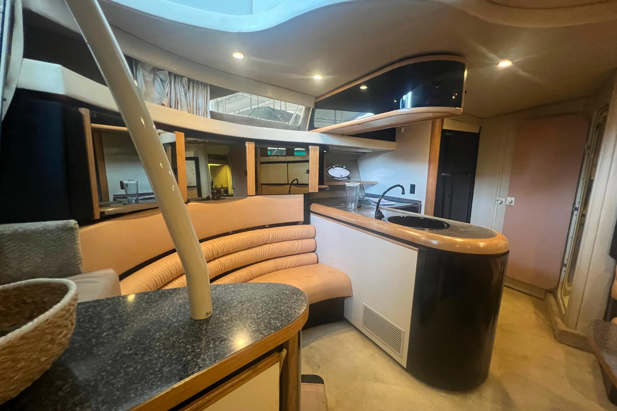 Luxurious interior of 1989 Bayliner 4285 Avanti yacht with modern kitchen and seating area.