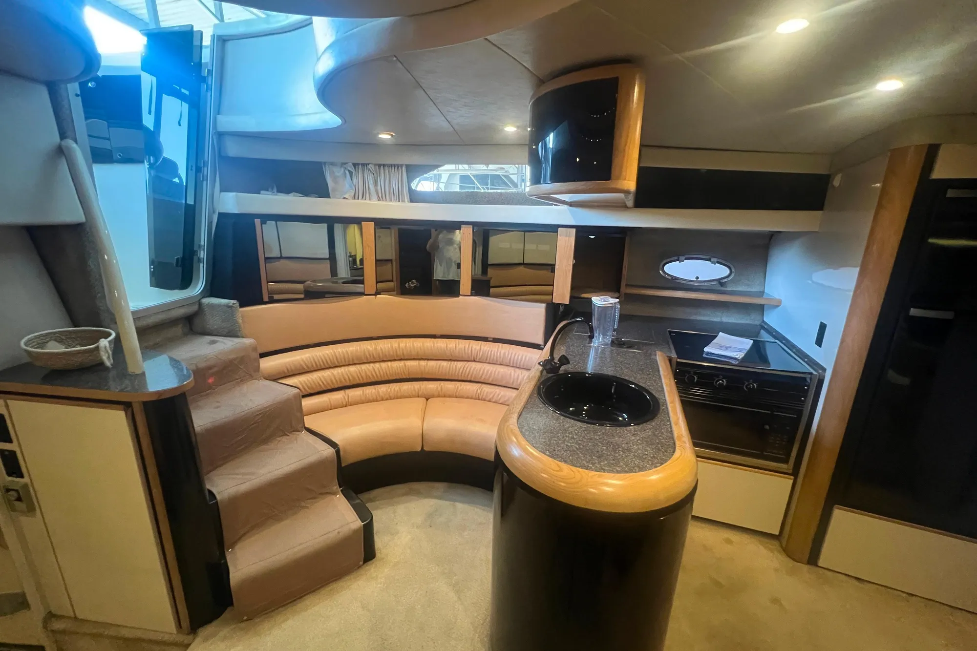 1989 Bayliner 4285 Avanti interior with curved seating, kitchenette, and modern design elements.