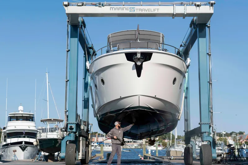  Yacht Photos Pics 2024 Greenline 45 Fly yacht being lifted at a marina with a travel lift.