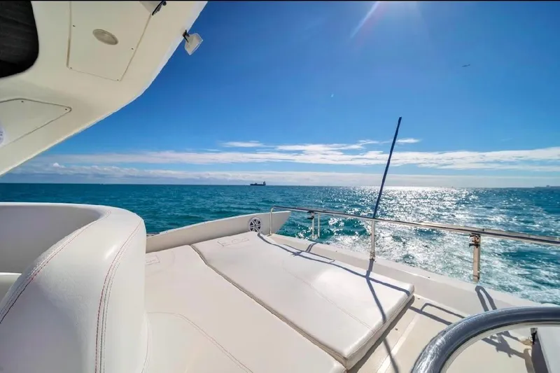  Yacht Photos Pics Luxurious 2006 Azimut 50 Fly yacht deck with ocean view under clear blue sky.