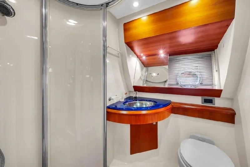  Yacht Photos Pics Luxurious bathroom in 2006 Azimut 50 Fly yacht with modern fixtures and elegant wood accents.