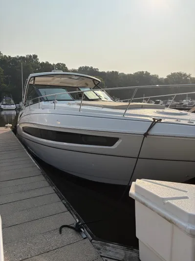 Jac & Wood Yacht Photos Pics 2017 Cruisers Yachts 380 Express docked at marina, sunny day, lush trees in background.