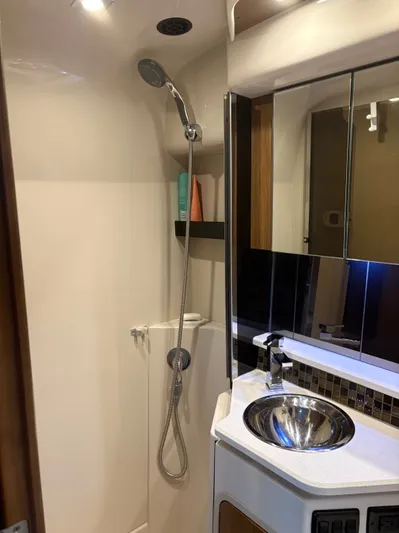 Jac & Wood Yacht Photos Pics 2017 Cruisers Yachts 380 Express bathroom with shower, sink, and mirror.
