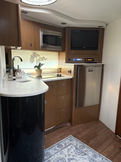 Jac & Wood Yacht Photos Pics Luxurious 2017 Cruisers Yachts 380 Express interior with modern kitchen amenities.