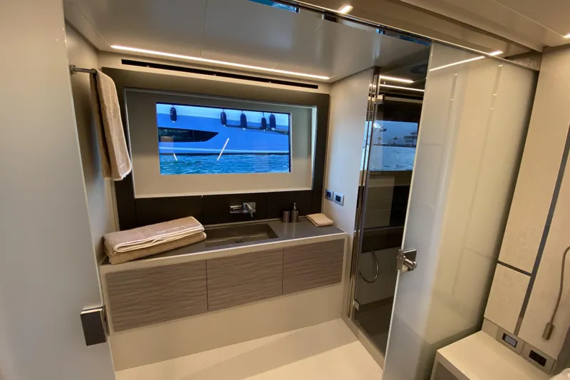  Yacht Photos Pics Luxurious bathroom interior of 2023 Pershing 6X yacht with modern fixtures and sea view.