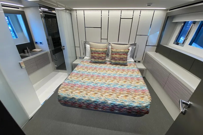  Yacht Photos Pics Luxurious bedroom interior of 2023 Pershing 6X yacht with modern design and colorful bedding.